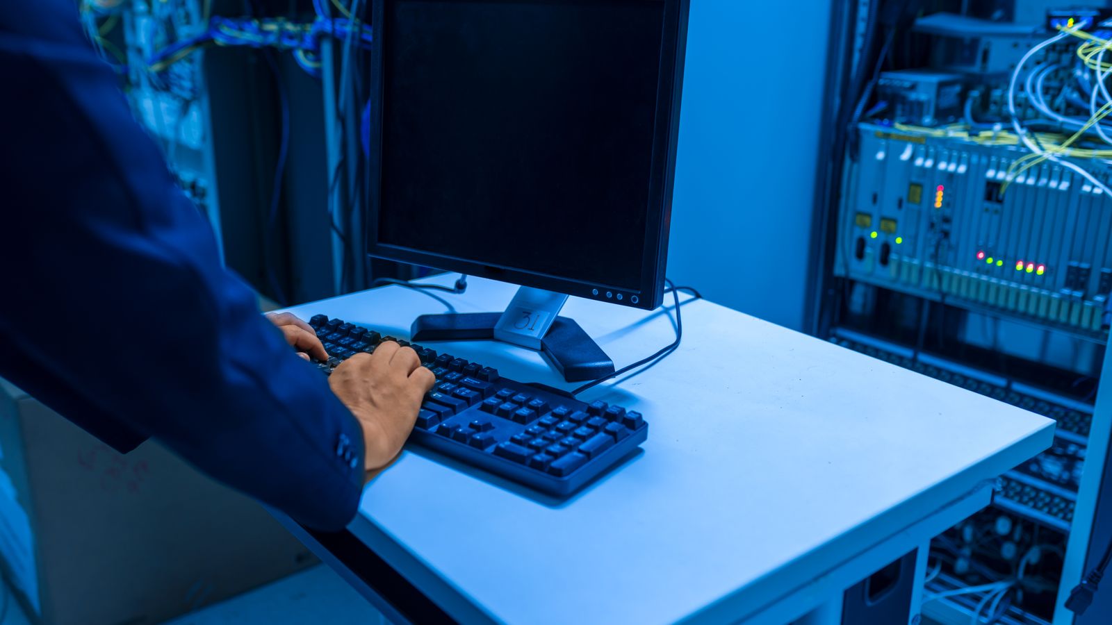 IT professional monitoring backup and recovery systems in a server room