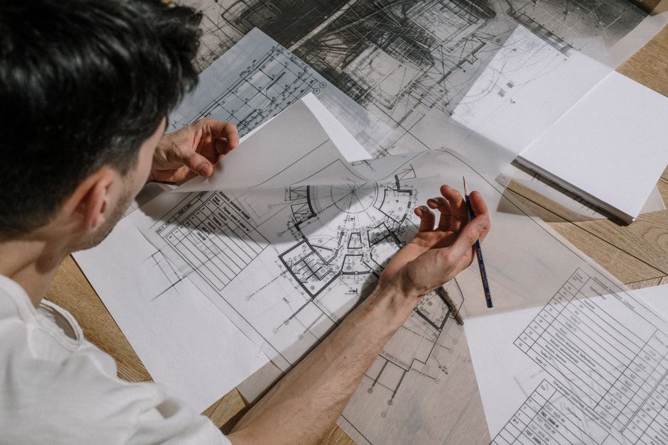 Engineer reviewing well pad instrument datasheets and technical drawings