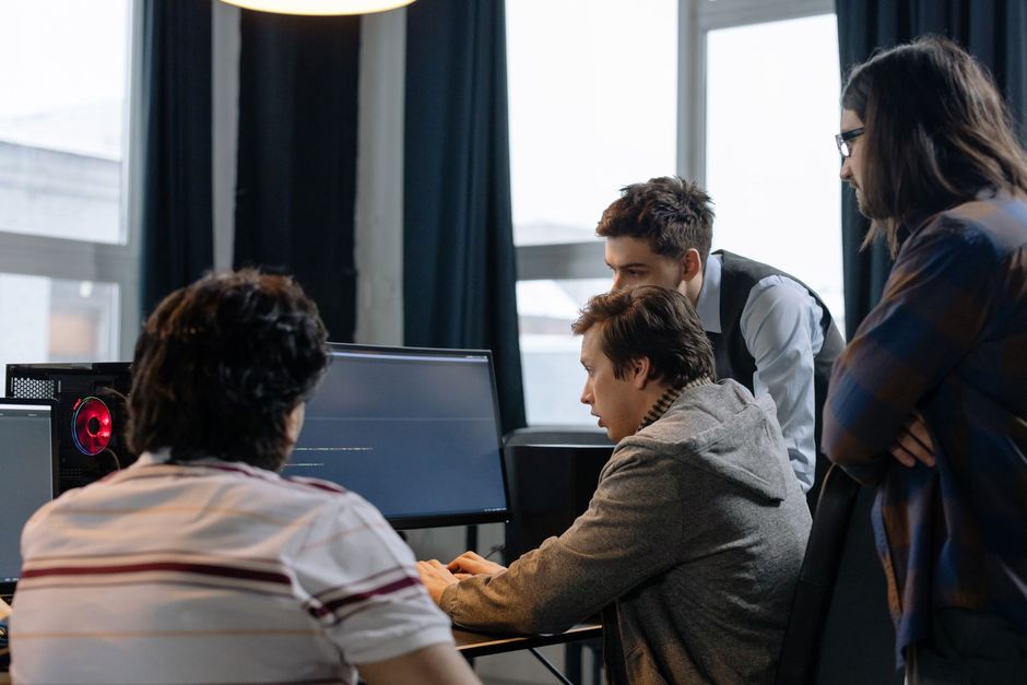 IT staff working together at computer workstations